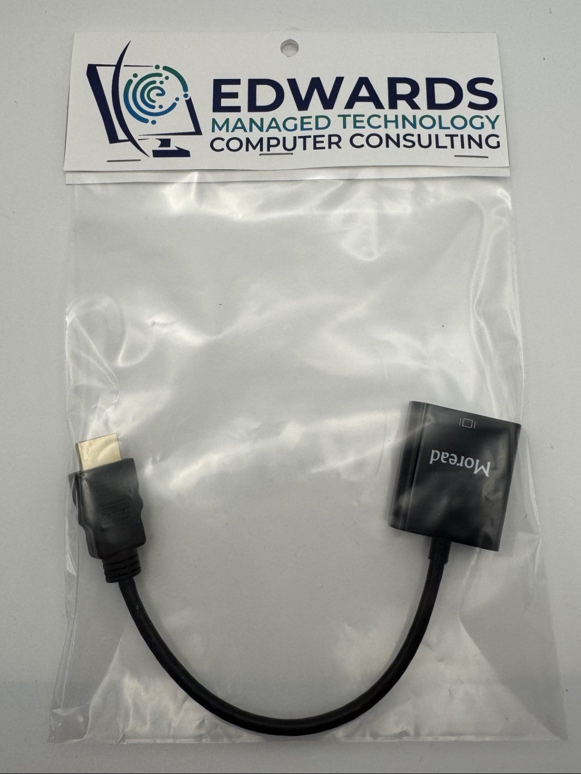 Black cable with connectors in a clear bag labeled 'Edwards Managed Technology Computer Consulting'.