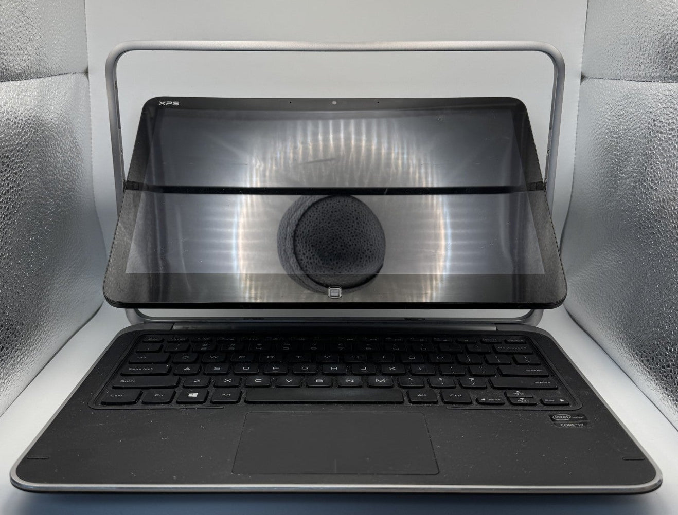 Laptop with screen removed inside a metallic container