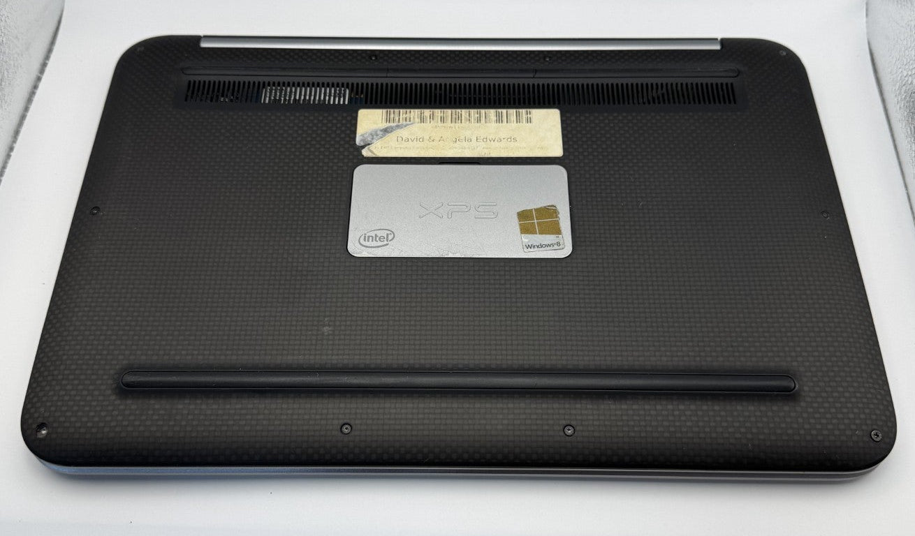 Black electronic device with a card on a white surface